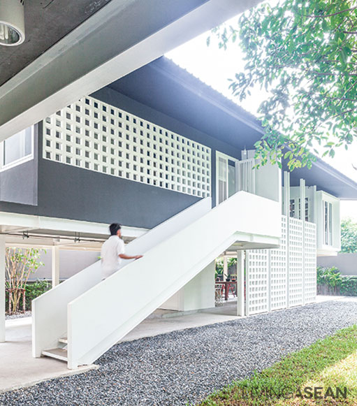 The staircase leading to the second floor has simple looking handrails that match the style of the house.