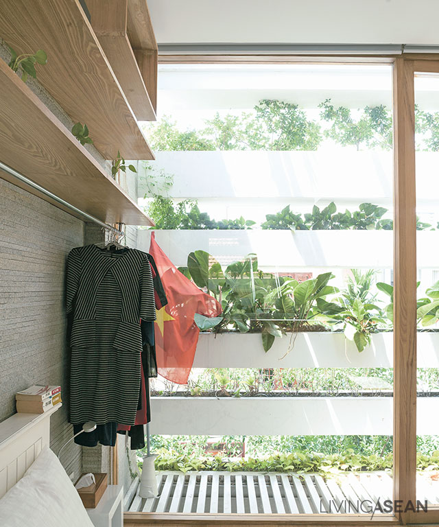 Besides giving privacy and cooling shade to the house, the planter boxes and leafy vegetation also act as a safety feature. 