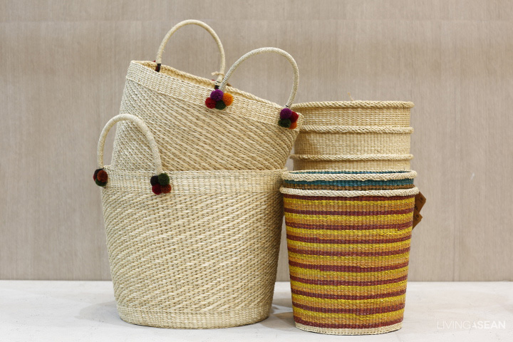 Colored strips and small Northern Thai ornaments add interesting elements to round vetiver baskets.