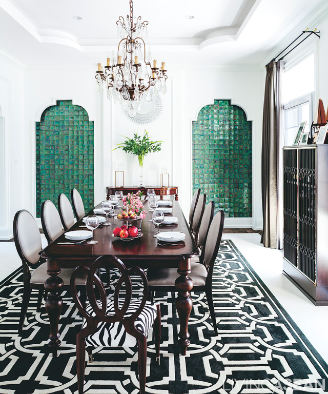 The dining area comes in white from floor to ceiling to walls. A green mosaic tile and black and white graphic pattern on the rug help keep the space from appearing too empty and bland. 