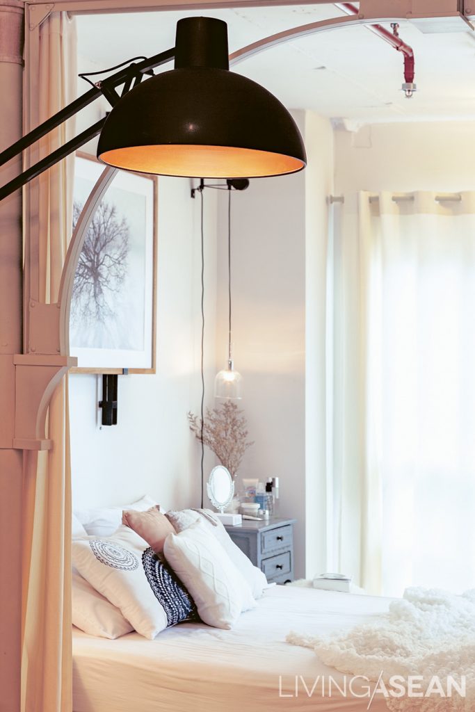 The bedside lamp design was derived from one of Priyawat’s projects for a hotel. To contrast with the lamp’s modern style, Priyawat paired it with a vintage wooden bedside table.