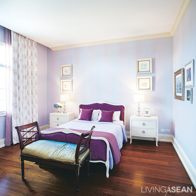 The small bedroom features a gorgeous combination of lavender, white, and cream made for a sweet atmosphere. 