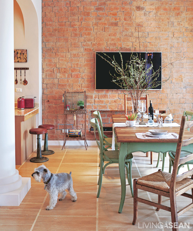 The dining area connecting to the kitchen gives the feeling of a French bistro, with light and airy décor.