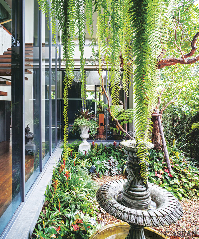 Near the stairway to the second floor is a courtyard where a tiny English garden reigns supreme, visible from every corner of the house.