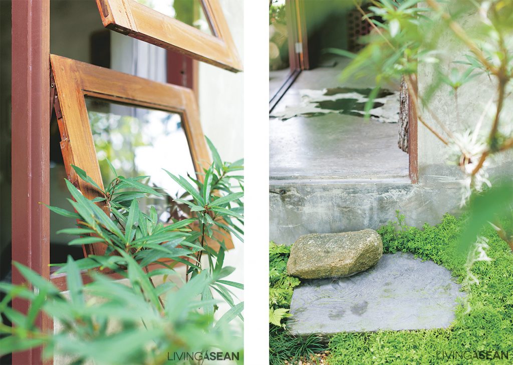 Big rocks are used to make steps that connect the front porch to the garden below. Together they add a country rustic feel to the lush green setting.