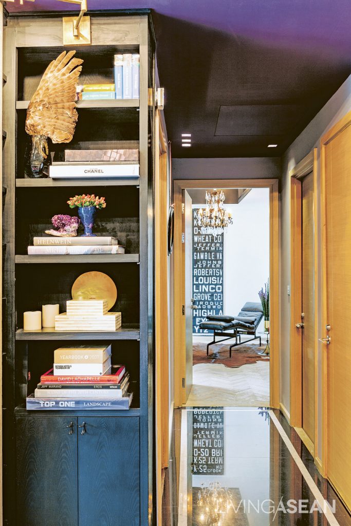 A connecting walkway features black granite flooring with a gold trim. It is designed to match the mysterious-looking ceiling in black.