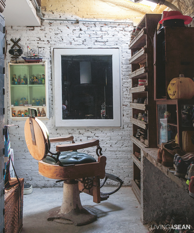 Vintage barber chair, wooden shoe cabinet, brick against bare concrete: more gnarly cool chic. 