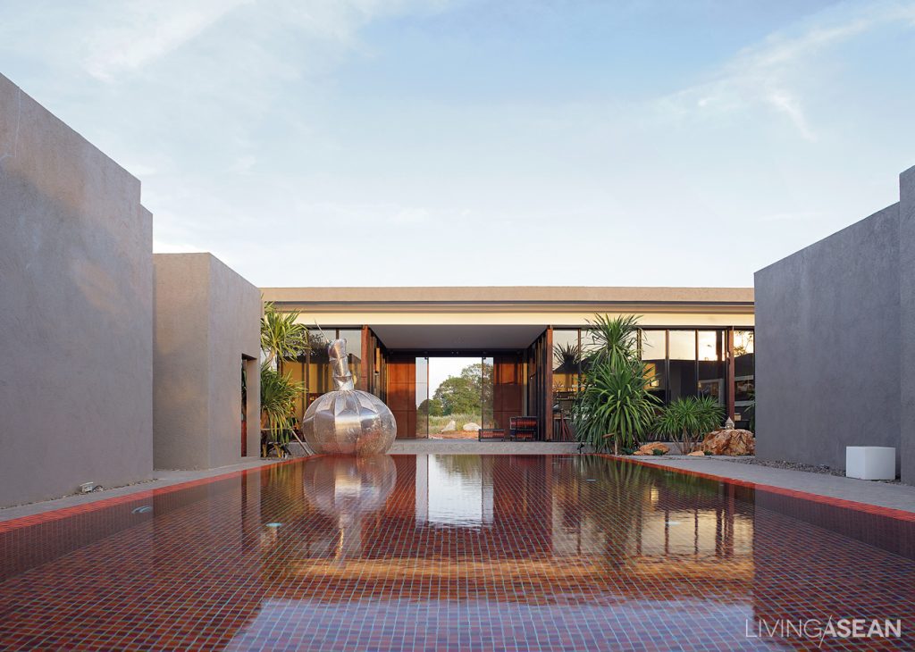 Beautiful abstract sculpture adds a modern appeal to the pool.
