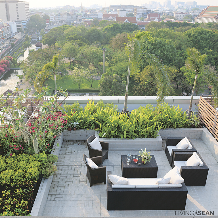 An al fresco sitting area provides outdoor comforts and a 360-degree view of Old Bangkok. A sky garden filled with thriving houseplants adds green urban space to the top of the building – frugal ideas to reconnect with nature.