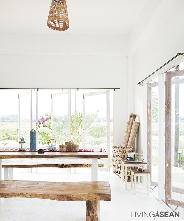 A large dining table is set facing outward to soak up spectacular mountain views. 