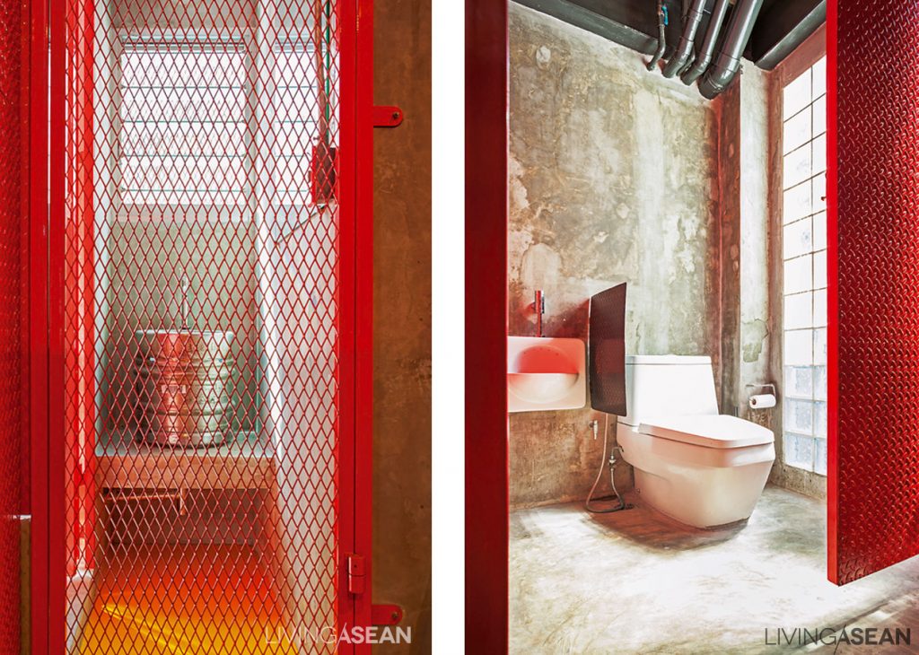 [Left] An expanded metal mesh door adds an airy feel to the dry part of a bathroom. Polished concrete finishes paired with a stainless steel bucket make a simple set of wash basin and counter. [Right] A red custom-made metal door breaks the rawness of unpainted concrete. 