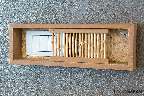 Light switches are hidden in plain sight behind knotted bamboo sticks put together in a miniature lattice.