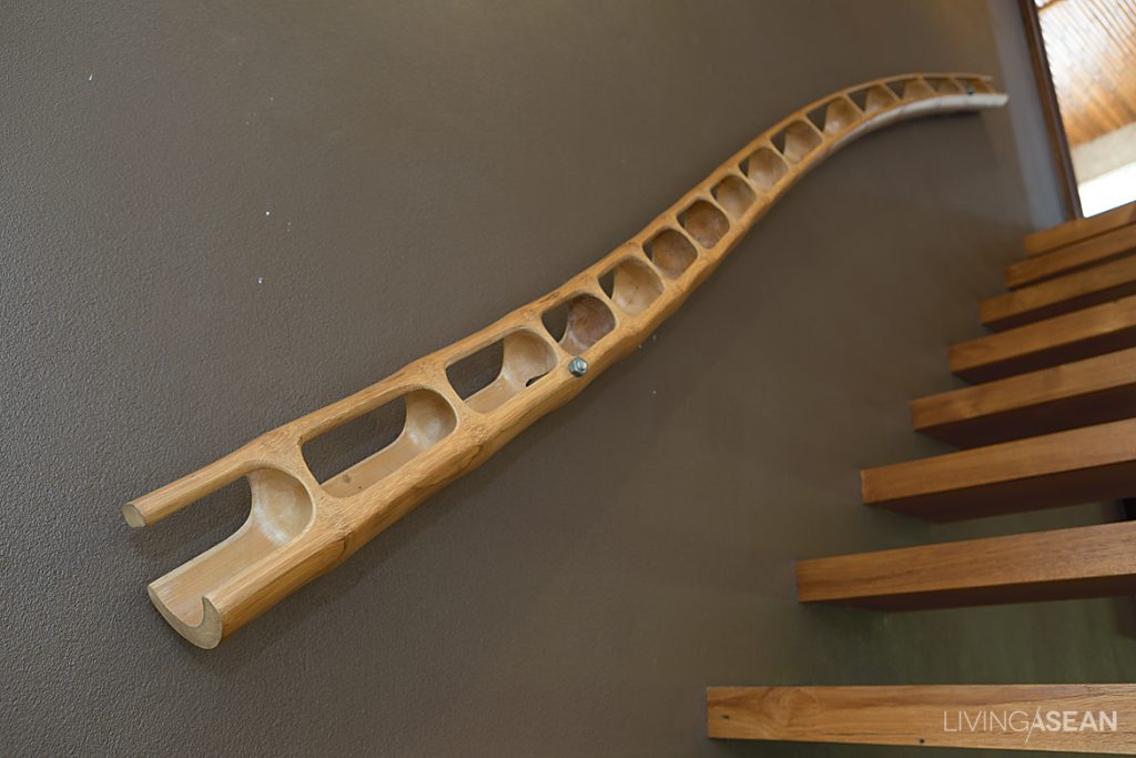 Rustic handrail is crafted of a giant bamboo pole, part of the designer’s rare collectibles.