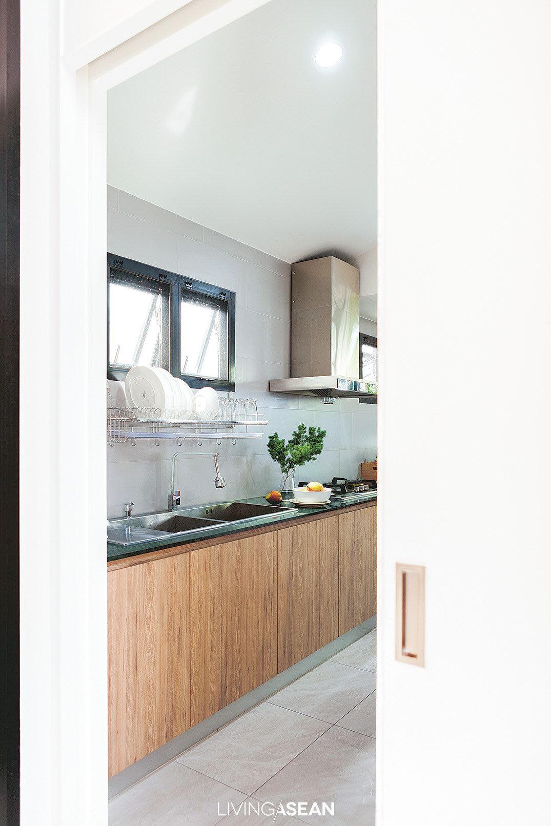 A solid wooden door separates the kitchen from family room. It’s one clever hack to banish the smoke and cooking orders, plus it’s easy to keep clean.