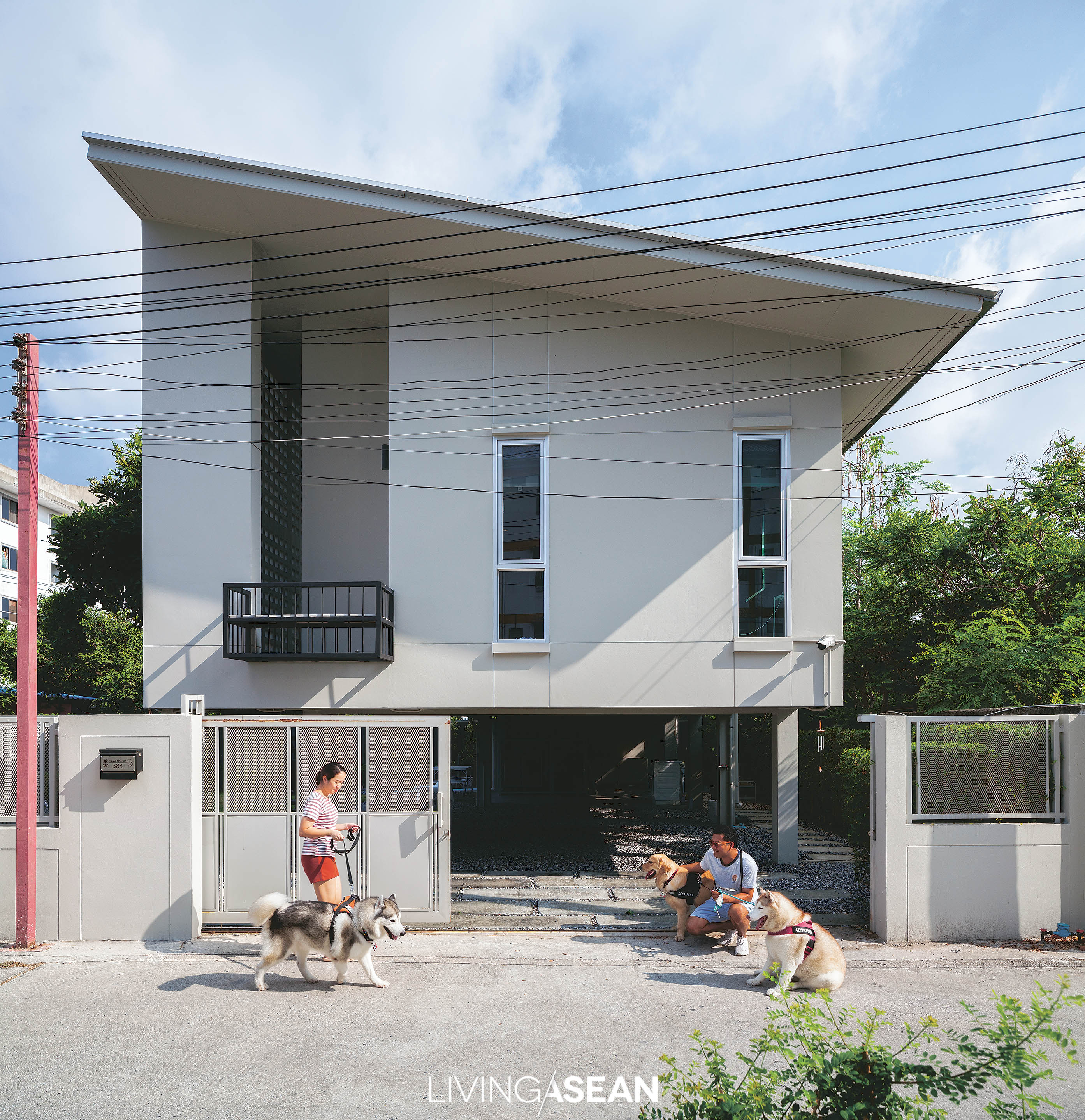 The modern shed roof dwelling is raised high above the ground on piles reminiscent of traditional Thai houses. The under-floor space has a carport, laundry area, and room for dogs to lounge about, play and get some exercise.