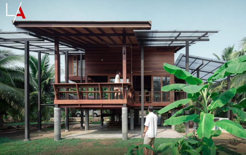 A Beautiful Wooden House on Stilts in a Coconut Grove